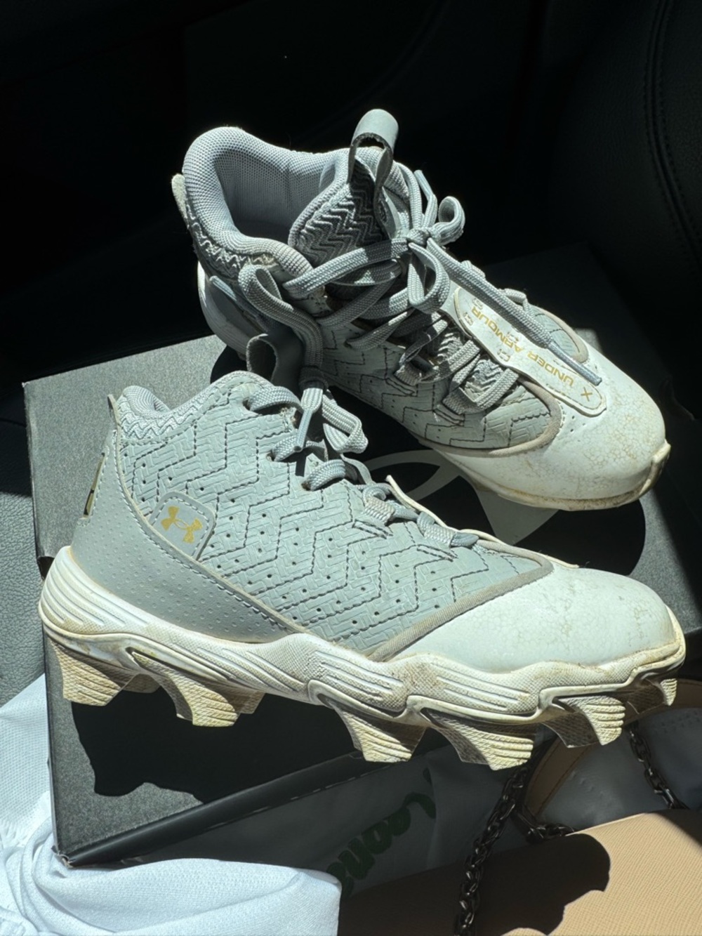 Under Armour Light Gray Youth Cleats with Gold Logo